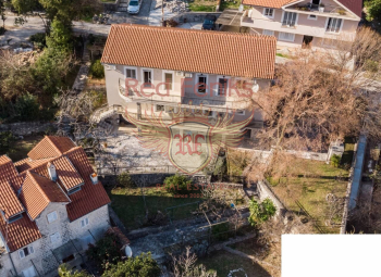For sale house consisting of two mirrored halves, i.
